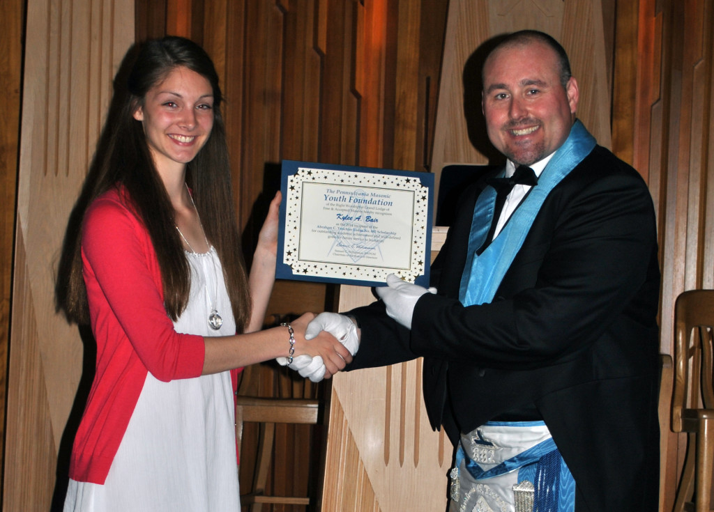 Miss Bair receives the scholarship from Bro. Stephen E. Poff, Worshipful Master.