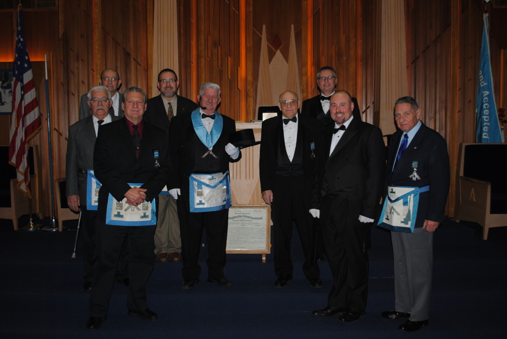 The Past Master of Abraham C. Treichler Lodge No. 682 congratulate Bro. H. Eugene Geib (Center, in regalia) on being installed as the 100th Worshipful Master of the Lodge. 